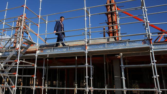 Joel Weekes inspects the work at the new St Greg's Junior School. (AAP Image/Angelo Velardo)