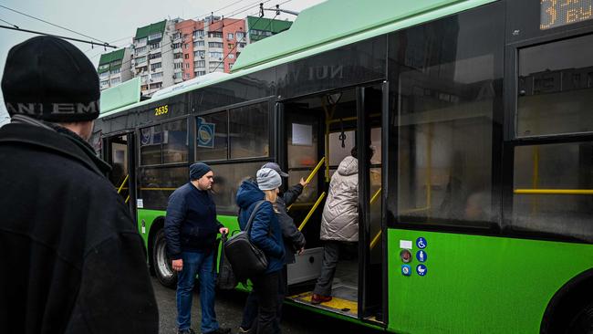 Passengers get on a trolleybus on a street of Kharkiv after the resumption of urban electric transportation services which were halted after a massive missile attack in the city.