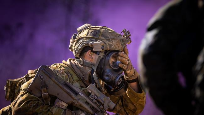 An Australian army soldier from the 3rd Battalion, Royal Australian Regiment equips a gas mask during a chemical, biological, radiological and nuclear defence (CBRND) serial during the 2022 Duke of Gloucester Cup in Singleton. *** Local Caption *** Australian Army infantry soldiers from across Australia tested their core skills for the prestigious Duke of Gloucester Cup at the School of Infantry, near Singleton in NSW, July 31 - August 5 2022. The Duke of Gloucester Cup is the Armyâ€™s premier military skills competition, pitting the best Royal Australian Corps of Infantry rifle sections from each unit against one another through a series of challenging activities that test their core infantry skills, including marksmanship, tactics, teamwork and fitness. Along with the Duke of Gloucester Cup, five other trophies are awarded: Sir Arthur MacDonald Trophy for best foundation war-fighting skills; Gurkha Trophy for best live-fire shooting; Royal Ulster Rifles Trophy for best falling plate shooting; OSCMAR Trophy for best battle endurance; and the DSM Roche CSC Memorial Cup for best individual soldier. The Duke of Gloucester Cup was created by Prince Henry, Duke of Gloucester, in 1946, while serving as the Governor-General of Australia.