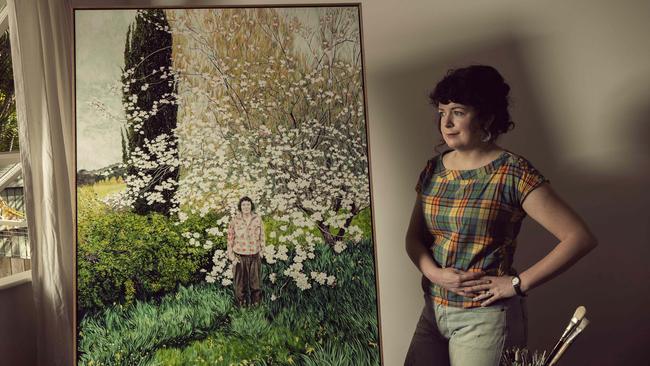 Brisbane artist Monica Rohan in her home studio with her portrait of fellow artist Lucy Culliton. Picture: Glenn Hunt