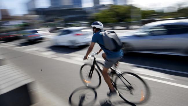 MELBOURNE, AUSTRALIA - NewsWire Photos FEBRUARY 24, 2021: A cyclist rides through Melbourne CBD. A tough new crackdown on speeding cyclists and scooters in Victoria could see riders facing  fines of up to $1600.Picture: NCA NewsWire / David Geraghty