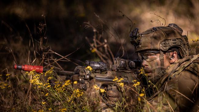 An Australian army soldier from the 3rd Battalion, Royal Australian Regiment, observes an enemy position during a section attack conducted during the 2022 Duke of Gloucester Cup in Singleton. *** Local Caption *** Australian Army infantry soldiers from across Australia tested their core skills for the prestigious Duke of Gloucester Cup at the School of Infantry, near Singleton in NSW, July 31 - August 5 2022. The Duke of Gloucester Cup is the Armyâ€™s premier military skills competition, pitting the best Royal Australian Corps of Infantry rifle sections from each unit against one another through a series of challenging activities that test their core infantry skills, including marksmanship, tactics, teamwork and fitness. Along with the Duke of Gloucester Cup, five other trophies are awarded: Sir Arthur MacDonald Trophy for best foundation war-fighting skills; Gurkha Trophy for best live-fire shooting; Royal Ulster Rifles Trophy for best falling plate shooting; OSCMAR Trophy for best battle endurance; and the DSM Roche CSC Memorial Cup for best individual soldier. The Duke of Gloucester Cup was created by Prince Henry, Duke of Gloucester, in 1946, while serving as the Governor-General of Australia.