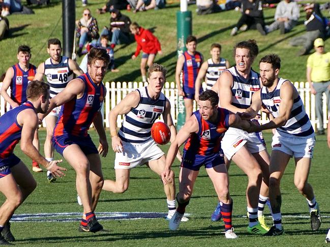 Port co-captain Tom O'Sullivan is held as he reaches for the ball. Pic: Jenny Tserkezidis