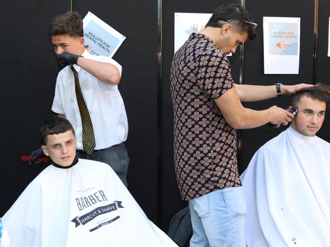 Kids having their mullet haircuts at school lunchtime at St Augustine's College in Brookvale. Picture: Supplied