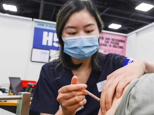 ADELAIDE, AUSTRALIA - NewsWire Photos NOVEMBER 4, 2021: SA Health vaccinator Xuan gives paramedic Sharon Hennessy a Covid booster vaccine at Wayville Vaccination Clinic. Picture: NCA NewsWire/Brenton Edwards