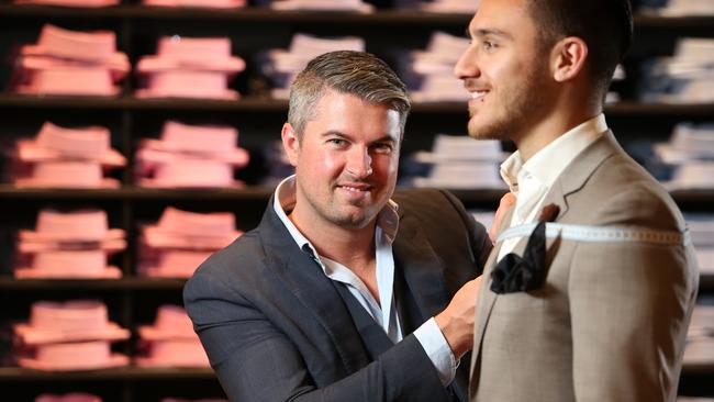 David Jackson, left, measures up Costa Sclavos for a new suit at the Peter Jackson menswear store at Westfield Sydney. Picture: Richard Dobson