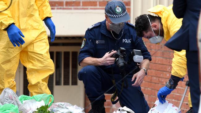 Police officers search items from a property in relation to counter-terrorism raids in Lakemba. Picture: AAP