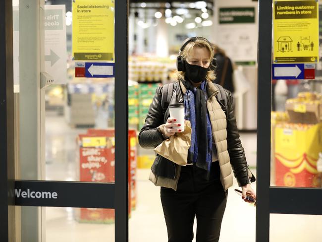 A shopper wears a mask as she leaves Woolworths Metro, Chatswood. 3rd August  2020. Picture by Damian Shaw