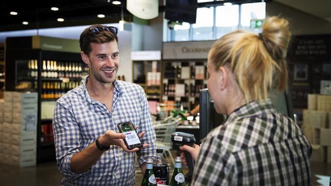 Gary Elphick, 30, using his mobile phone to scan his loyalty card instore.