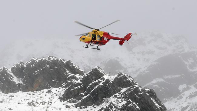 The Westpac rescue helicopter rescues an injured snowboarder at the top of The Needles West of Maydena. Picture: ZAK SIMMONDS