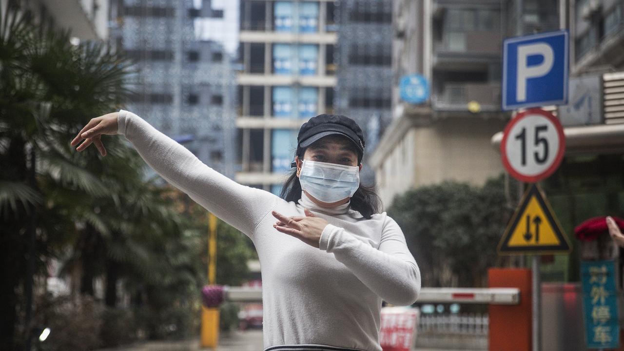 A woman wears a protective masks while exercising in Wuhan, China. Picture: Getty