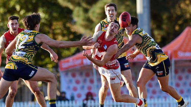 North Adelaide’s Alex Spina handballs through traffic. Picture: Tom Huntley.