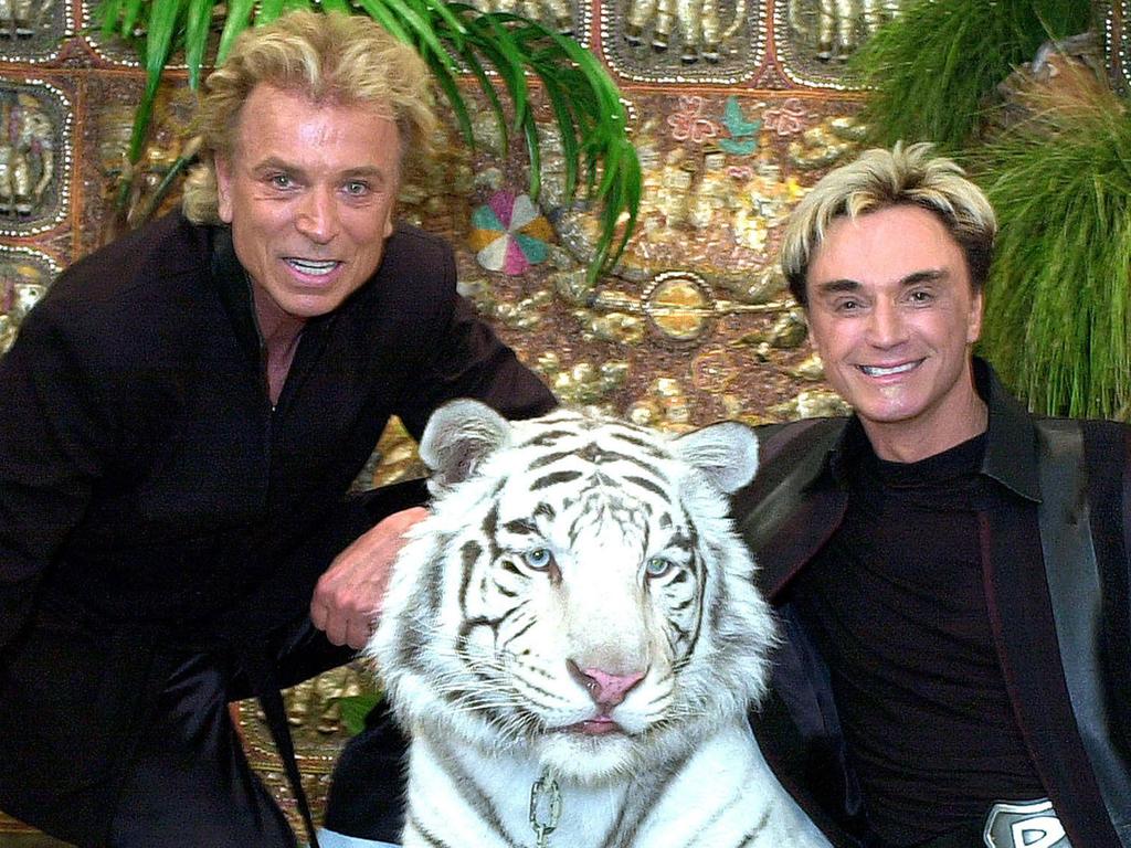 Siegfried with Roy Horn and their performing white tiger, Montecore.