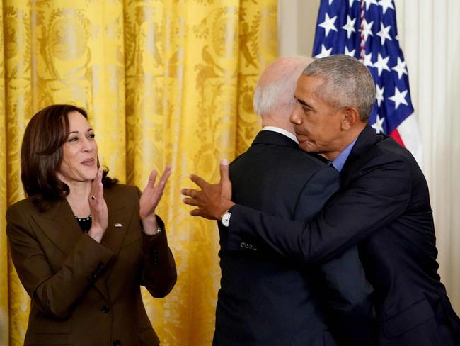 (FILES) US Vice President Kamala Harris (L) applauds as US President Joe Biden and former President Barack Obama embrace prior to delivering remarks on the Affordable Care Act and Medicaid in the East Room of the White House in Washington, DC, on April 5, 2022. US President Joe Biden announced July 21, 2024 that he is dropping out of his reelection battle with Donald Trump, in a historic move that plunges the already turbulent 2024 White House race into uncharted territory. Biden also said he was endorsing Vice President Kamala Harris as the Democratic nominee for the 2024 election after he dropped out of the race. (Photo by MANDEL NGAN / AFP)