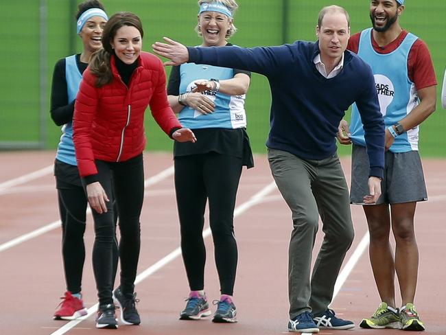 Prince William tries to put off his wife at the starting line. Picture: Alastair Grant/Getty Images