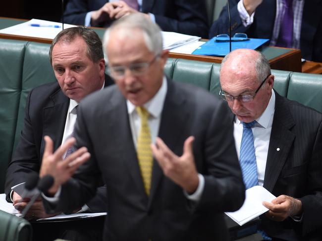 Nationals Barnaby Hoyce and Warren Truss listen, ahem, intently to Malcolm Turnbull’s Mal-splaining in Question Time yesterday. Picture: AAP Image/Lukas Coch