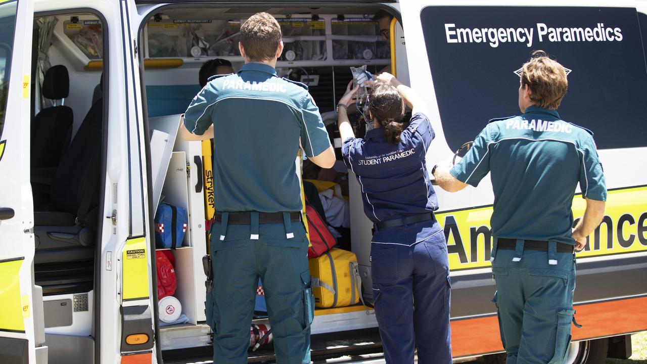 An ambulance crew tending to a patient on the Gold Coast on Australia Day. Picture: Nigel Hallett.