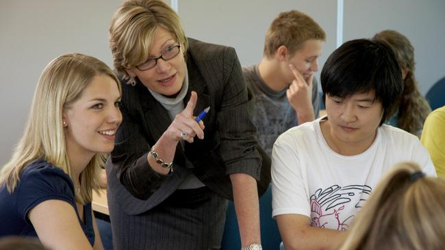 A teacher with students from Bond University in Queensland.