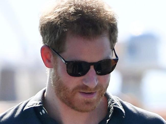 (FILES) In this file photo taken on October 22, 2018 Britain's Prince Harry and his wife Meghan, the Duchess of Sussex walk to attend a meet-the-people session at Kingfisher Bay Resort on Fraser Island. - Hailed as a breath of fresh air in a stuffy institution, Prince Harry's wife Meghan is set to test the limits of the British monarchy's desire to modernise when their first baby arrives this month. (Photo by DARREN ENGLAND / POOL / AFP)