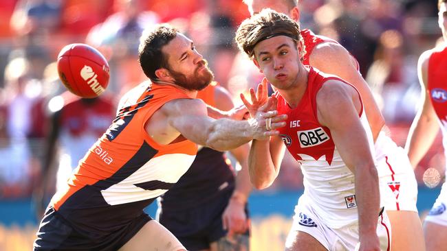 GWS ruckman Shane Mumford lunges at Sydney's James Rowbottom during the Derby match between the Giants and Swans in 2019. Picture: Phil Hillyard