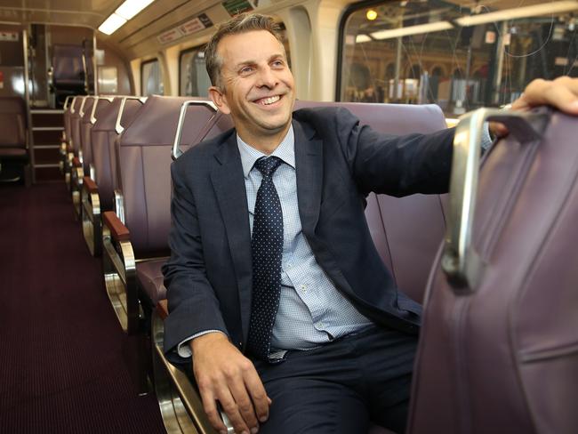 Commuters have called for trains to be upgraded as Mr Constance sits in one of the old trains. Picture: Richard Dobson