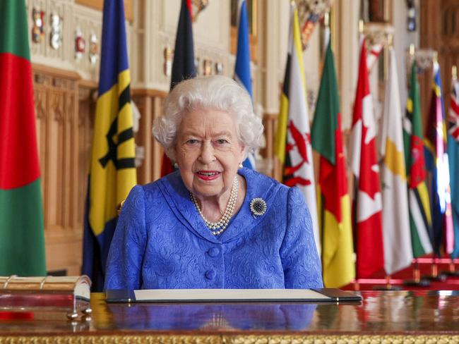 Britain's Queen Elizabeth II signs her annual Commonwealth Day Message in St George's Hall at Windsor Castle, Windsor, west of London on March 5, 2021. (Photo by Steve Parsons / POOL / AFP)