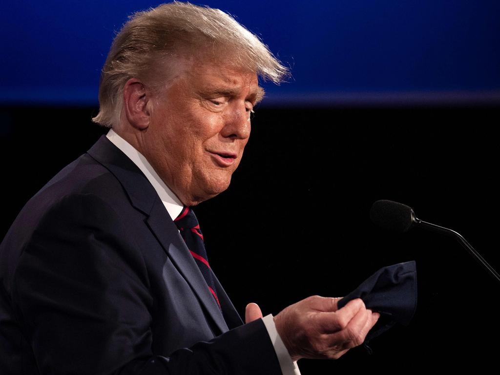 US President Donald Trump looks at his mask as he speaks with Democratic Presidential candidate and former US Vice President Joe Biden during the first presidential debate. Picture: JIM WATSON / AFP