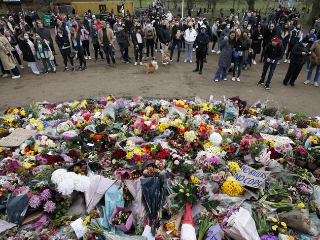 People gather to pay their respects on Clapham Common, where floral tributes have been placed for Sarah Everard in London, England. Picture: Hollie Adams/Getty Images