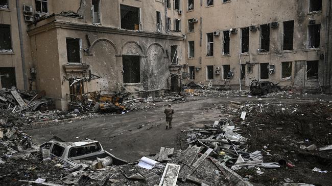 A Ukrainian soldier walks through rubble in Kharkiv. Picture: Aris Messinis/AFP