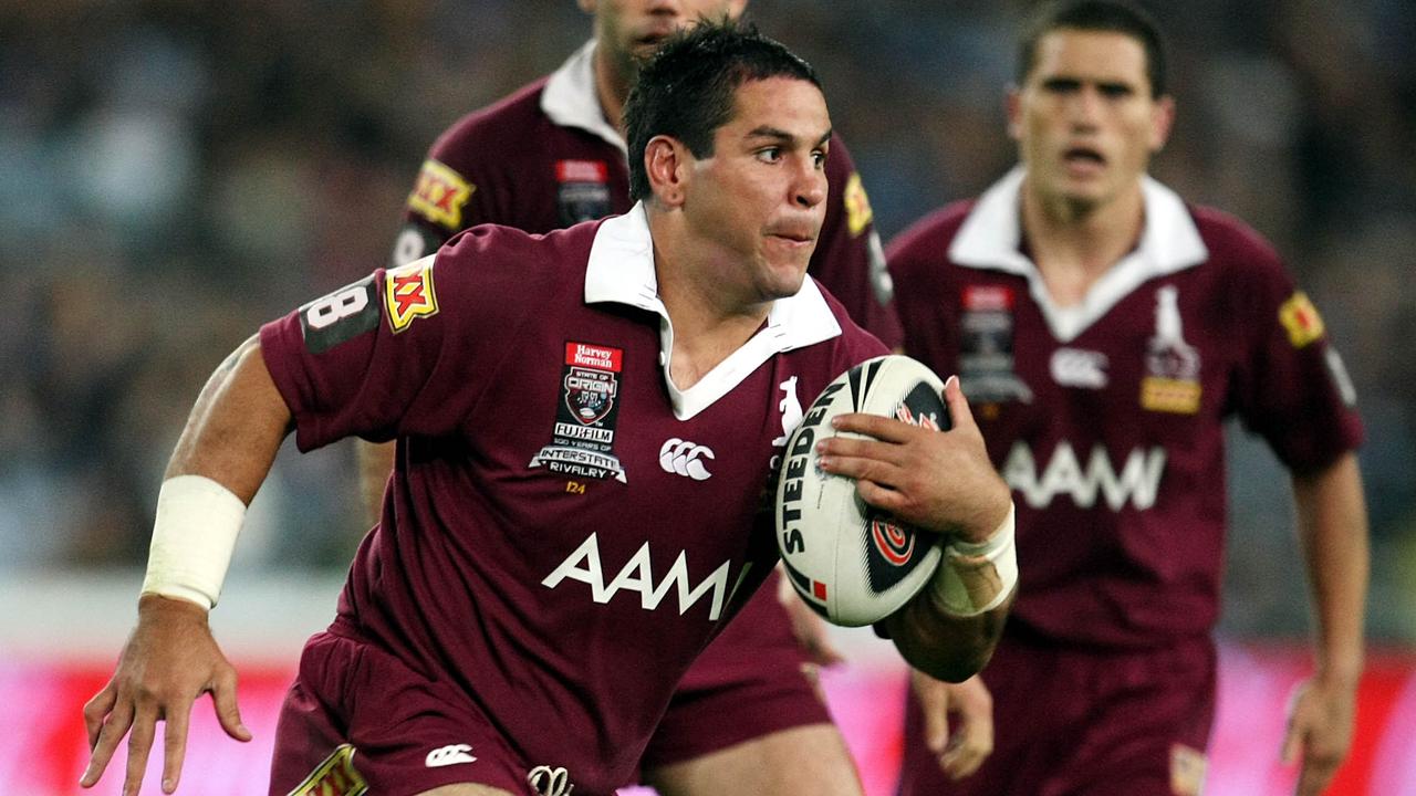 Carl Webb carries the ball for Queensland.