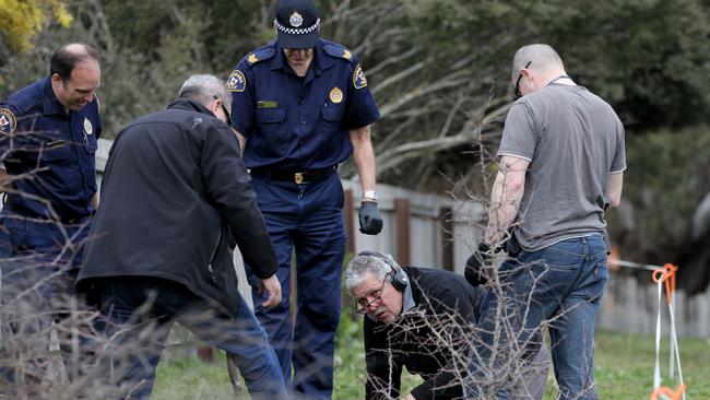 Tasmania Police officers searching today for bullet casings left behind after Campbell Town man Shane Barker was gunned down in August, 2009. Picture: LUKE BOWDEN