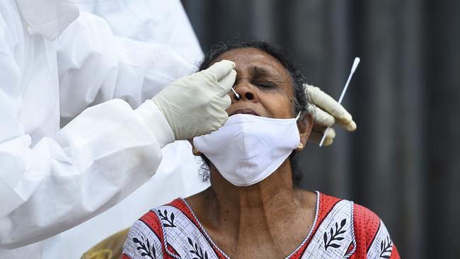 A health worker collects a swab sample from a resident to test for coronavirus in Colombo. Picture: AFP