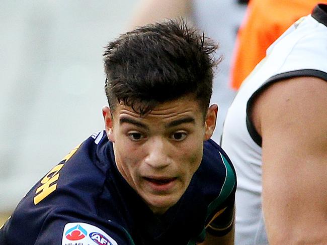 Australia U18 v. Collingwood VFL at MCG . Billy Stretch chases the ball. April 4th 2014 . Picture : Colleen Petch.