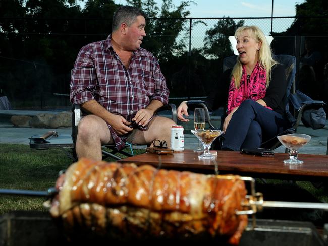 Katarina Carroll and husband Michael relax in their backyard as they wait for dinner to be ready. Photo by David Clark