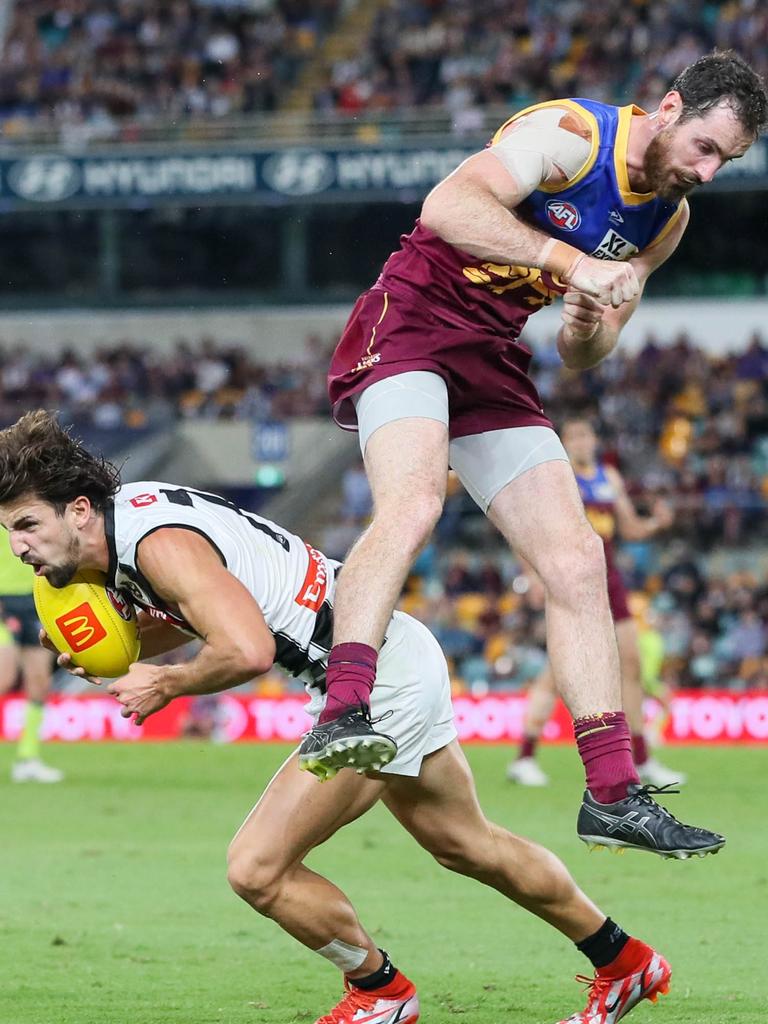 The young Pie falls to the ground after the late bump. Picture: AFL Photos via Getty Images