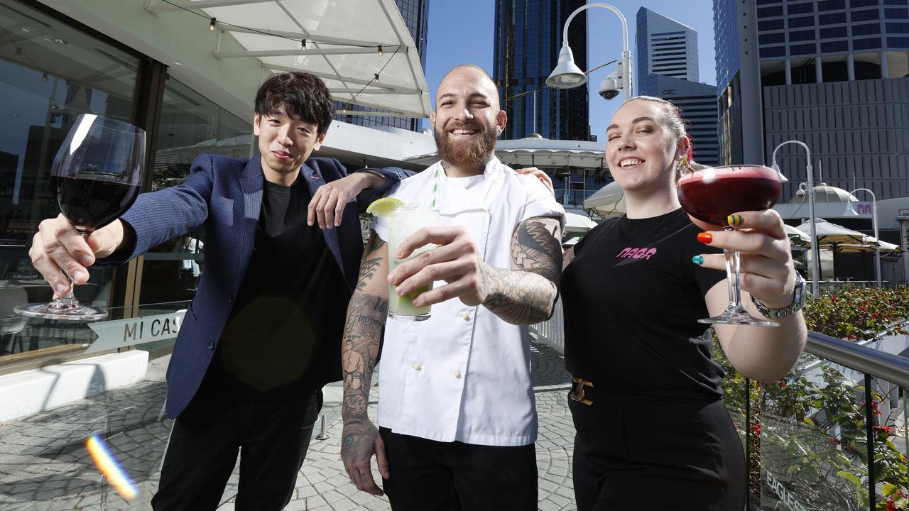 Tom Ahn - venue manager at Rico, Kadu Imbroisi - head chef at Fat Cow and Katelyn Armitt - supervisor at Naga Thai - who will be celebrating last drinks this weekend at Eagle Street Pier before the redevelopment begins. Picture Lachie Millard