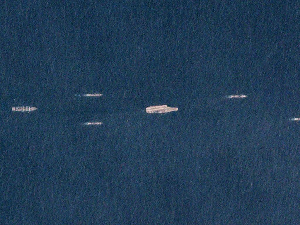 This picture showing China’s aircraft carrier and escorting warships was taken by a commercial satellite run by Planet Labs Inc. Military spy satellites have much greater resolution. Picture: AFP