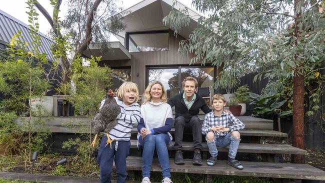 Alita McMenamin, Luke Middleton and their sons, Ned, 8, and Charlie, 6, live in one of the state’s most sustainable homes, MM House in Northcote. Picture by Wayne Taylor