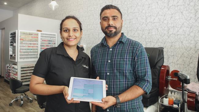 Cre8tive Nailz and Beauty owners Rosie and Manpreet Thind with their customer registration tablet. Picture: Glenn Campbell