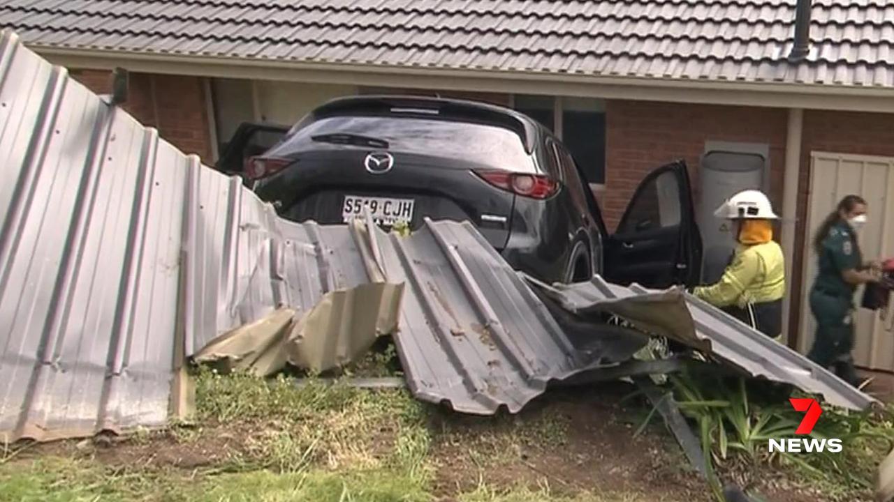 A woman has crashed her new 4WD through a fence and down an embankment in the southern suburbs. Picture: 7NEWS