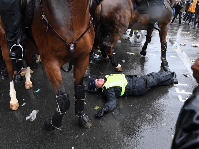 A mounted police officer lays on the road after being unseated from their horse, during a demonstration on Whitehall, near the entrance to Downing Street in central London on June 6, 2020, to show solidarity with the Black Lives Matter movement in the wake of the killing of George Floyd, an unarmed black man who died after a police officer knelt on his neck in Minneapolis. - The United States braced Friday for massive weekend protests against racism and police brutality, as outrage soared over the latest law enforcement abuses against demonstrators that were caught on camera. With protests over last week's police killing of George Floyd, an unarmed black man, surging into a second weekend, President Donald Trump sparked fresh controversy by saying it was a "great day" for Floyd. (Photo by DANIEL LEAL-OLIVAS / AFP)