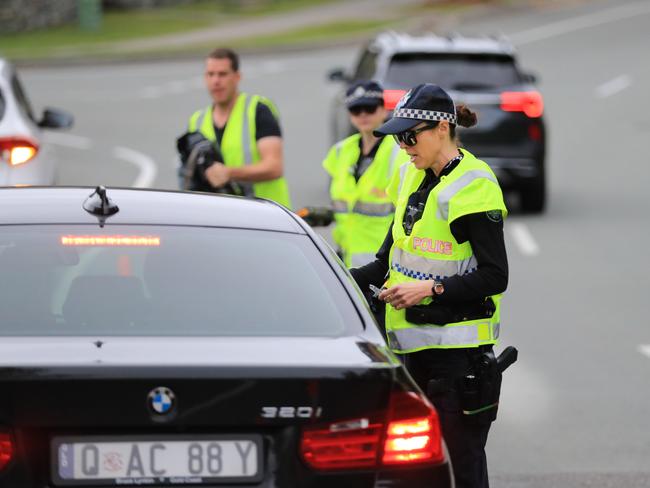 Coomera Police which are part of the Northern Patrols Group,  direct traffic to stop and pull over for a Random Breath Test on Rose Valley Drive Upper Coomera.                              Photo Scott Powick Newscorp