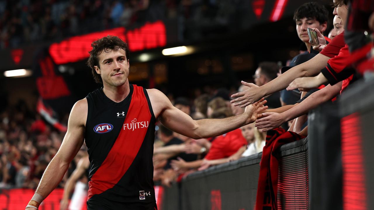 MELBOURNE, AUSTRALIA – MARCH 30: Andrew McGrath of the Bombers high fives fans after winning the round three AFL match between Essendon Bombers and St Kilda Saints at Marvel Stadium, on March 30, 2024, in Melbourne, Australia. (Photo by Quinn Rooney/Getty Images)