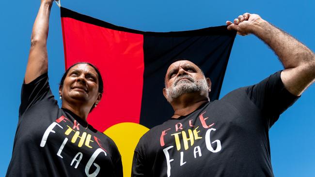 Nova Peris and Michael Long stand with the Aboriginal Flag. Picture: Che Chorley