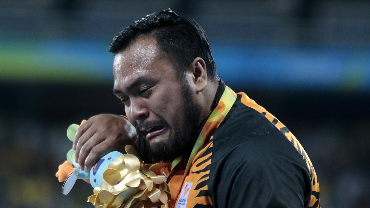 RIO DE JANEIRO, BRAZIL - SEPTEMBER 10: Gold medalist Muhammad Ziyad Zolkefli of Malaysia celebrate on the podium at the medal ceremony for the MenÃ¢s Shot Put Ã¢ F20 Final during day 3 of the Rio 2016 Paralympic Games at the Olympic Stadium on September 9, 2016 in Rio de Janeiro, Brazil. (Photo by Alexandre Loureiro/Getty Images)