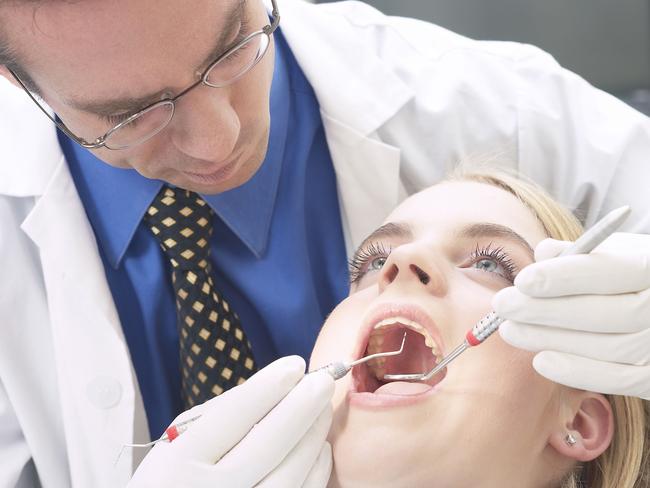 Dentist with patient. Thinkstock