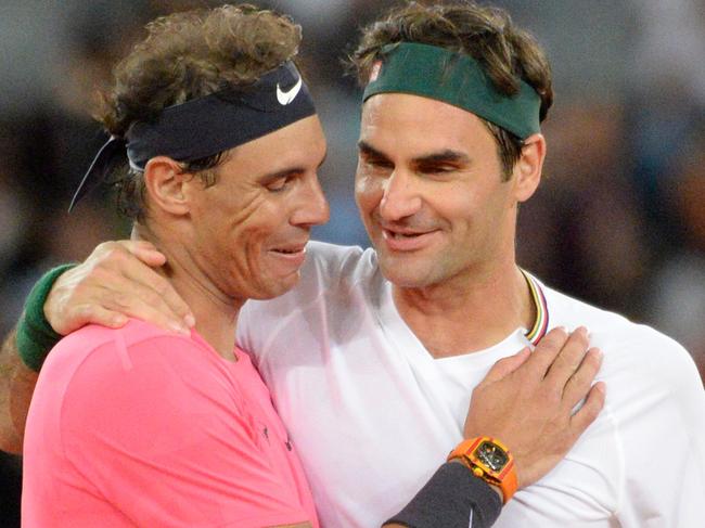 Switzerland's Roger Federer (R) hugs Spain's Rafael Nadal (L) during their tennis match at The Match in Africa at the Cape Town Stadium, in Cape Town on February 7, 2020. (Photo by RODGER BOSCH / AFP)