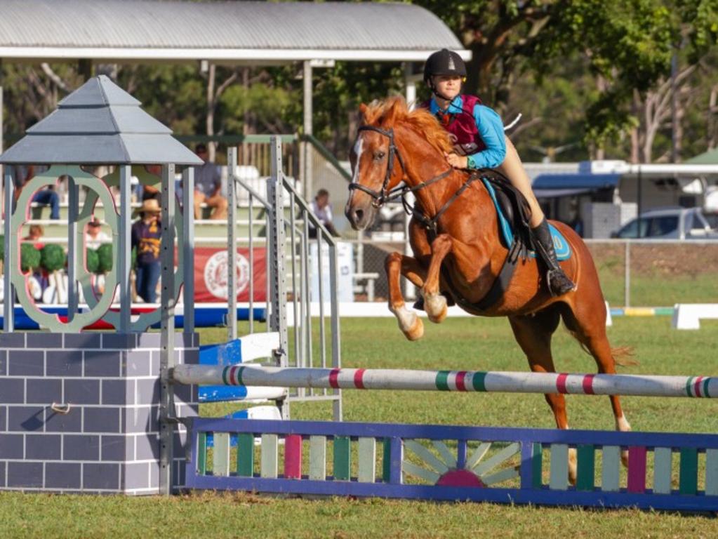 Marli Ferrington and her mount Basil clear the tower fence at the PQC State Showjumping Championships.