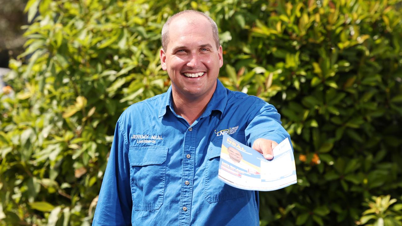 LNP candidate for the federal seat of Leichhardt Jeremy Neal hands out how to vote cards ahead of the federal election at the pre-polling centre at the Screen Queensland studios. Picture: Brendan Radke