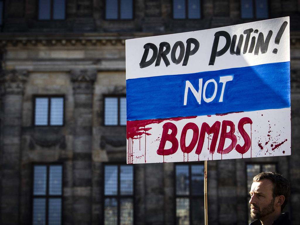 A man holds a placard during a demonstration in Amsterdam on Sunday. Picture: AFP